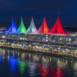 Canada place sails of light coloured blue, green, white and red