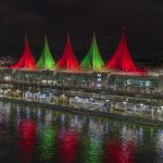 Canada place sails of light coloured green and red
